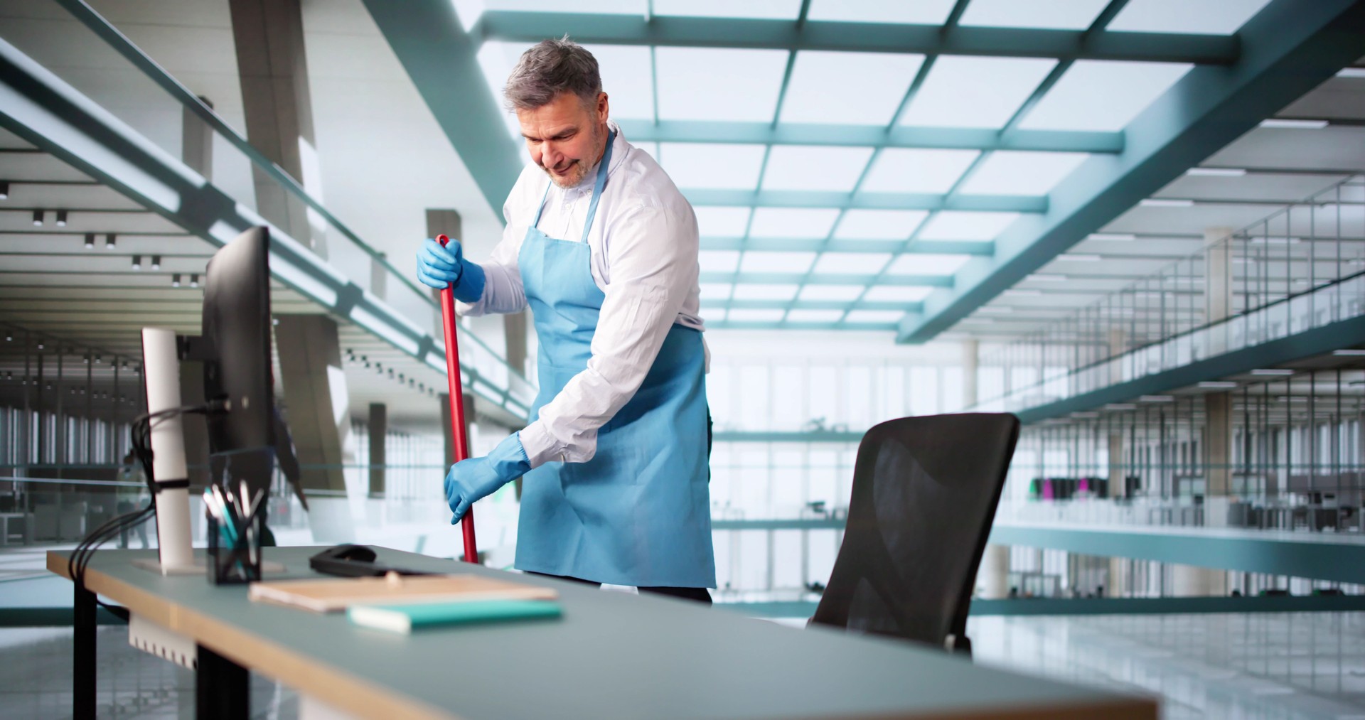 Male Janitor Cleaning Floor With Mop